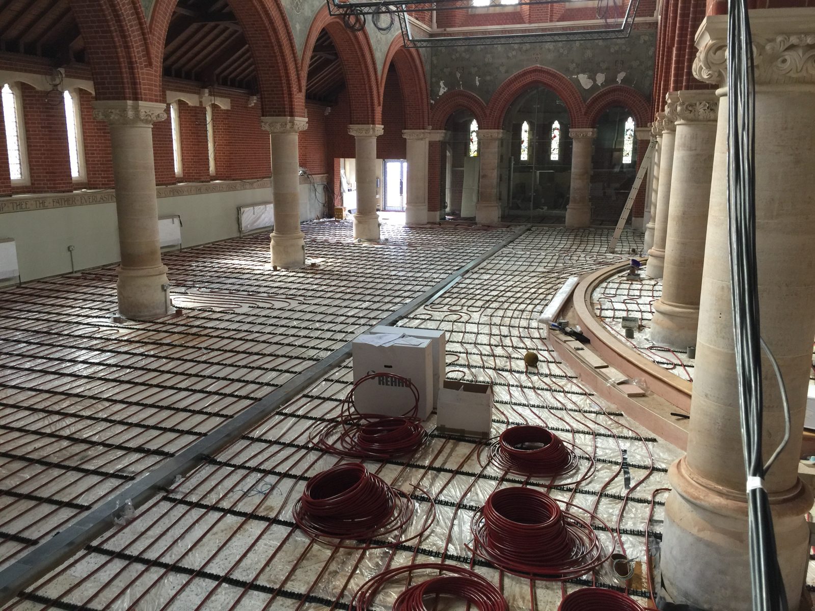 Underfloor heating being laid in a church, an EvoFLAME project